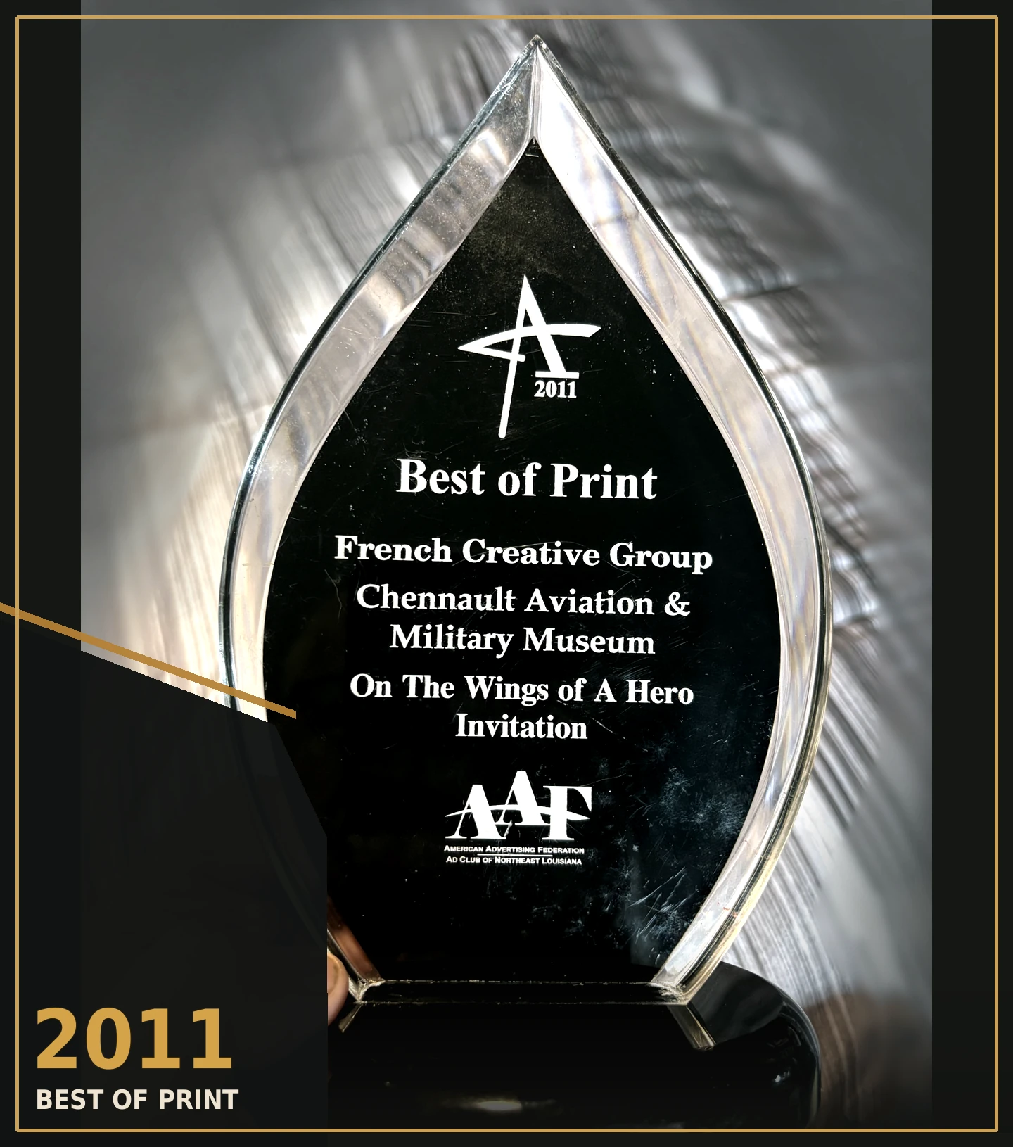 Editorial treatment of the original 2011 Best of Print ADDY award photograph, preserving engraved text; the original photograph opens on selection
