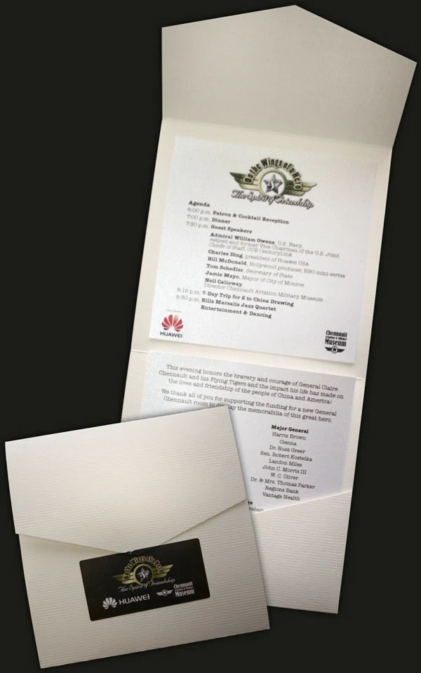 Folded textured white program and printed inserts with the gala identity