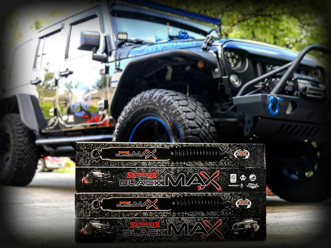 Two Skyjacker BLACK MAX boxes photographed in front of a custom off-road Jeep