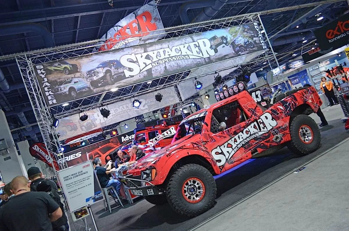 Completed red Skyjacker number 43 racing truck with aggressive black graphics at the show