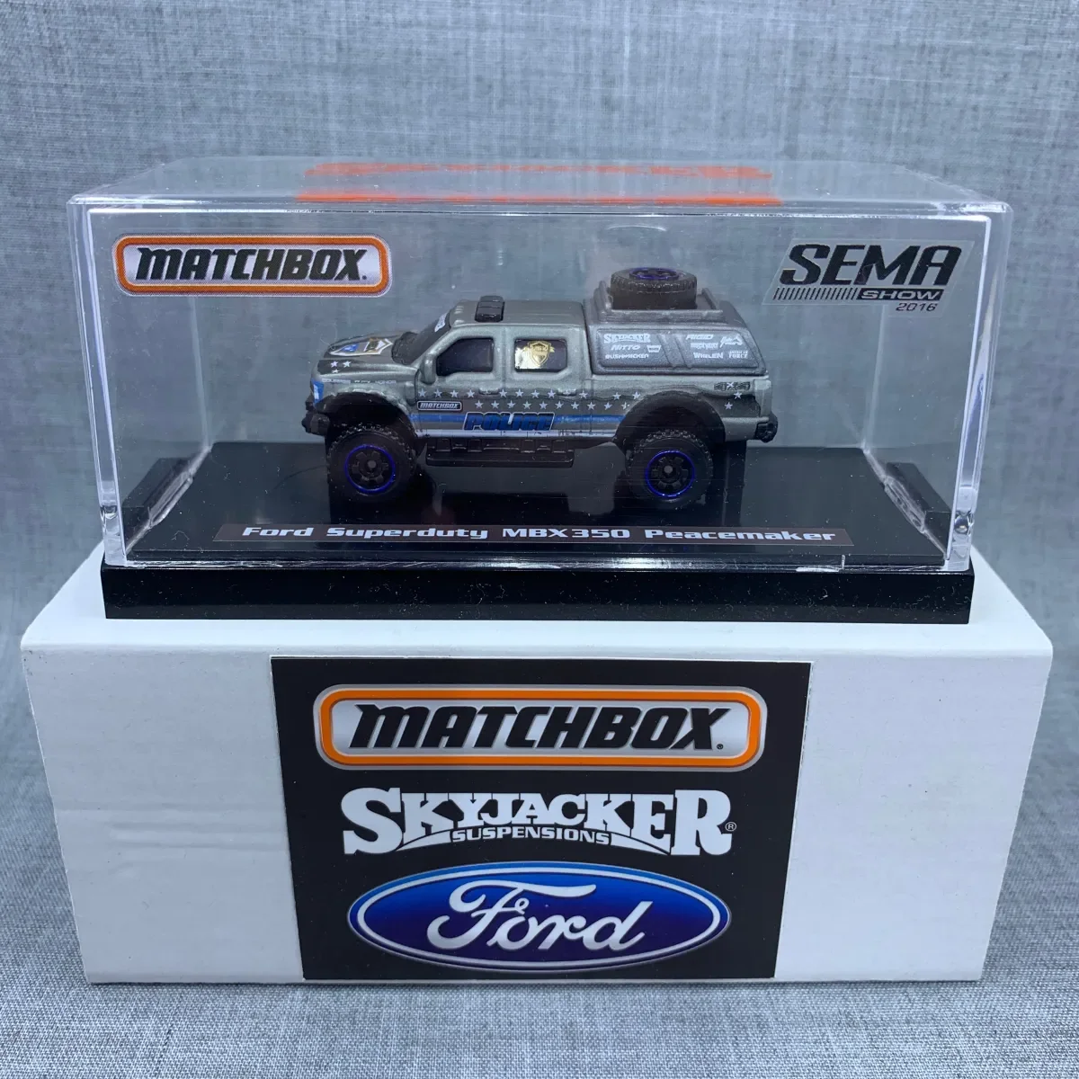 Matchbox collectible Ford Super Duty MBX350 Peacemaker model in a display case carrying Skyjacker, Matchbox and Ford branding